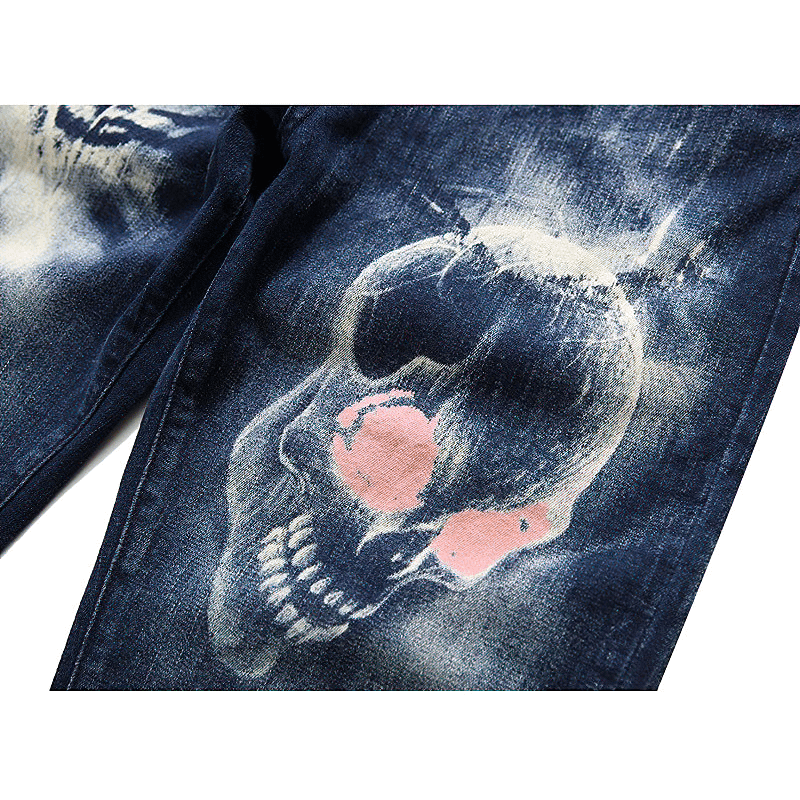 Close-up of men's 3D printed blue denim jeans featuring a skull print for unique streetwear style.