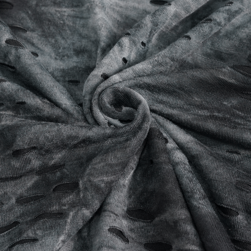 Close-up of textured dark fabric with asymmetrical cutouts, showcasing the unique style of the Rogue Edge men's top.