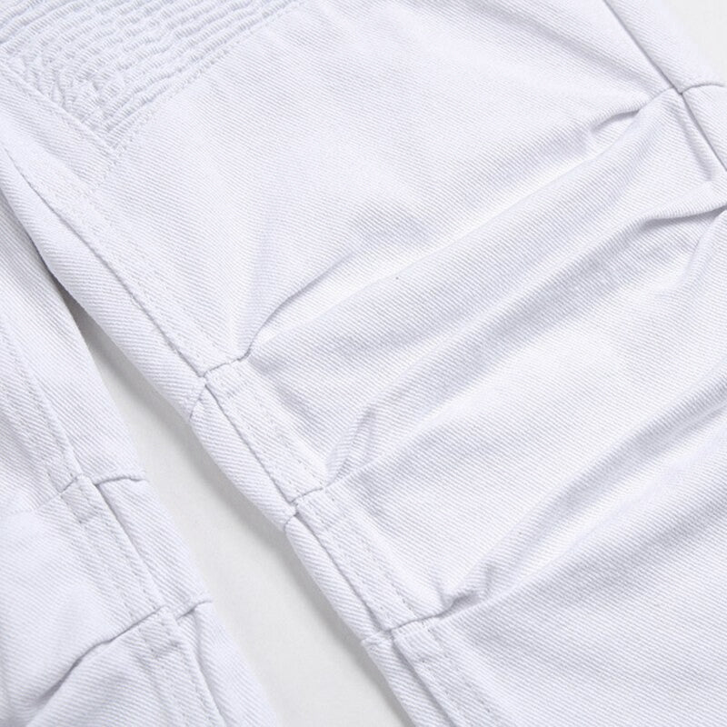 Close-up of white men's biker jeans showing pleated denim detailing and strong zippers for a stylish look.