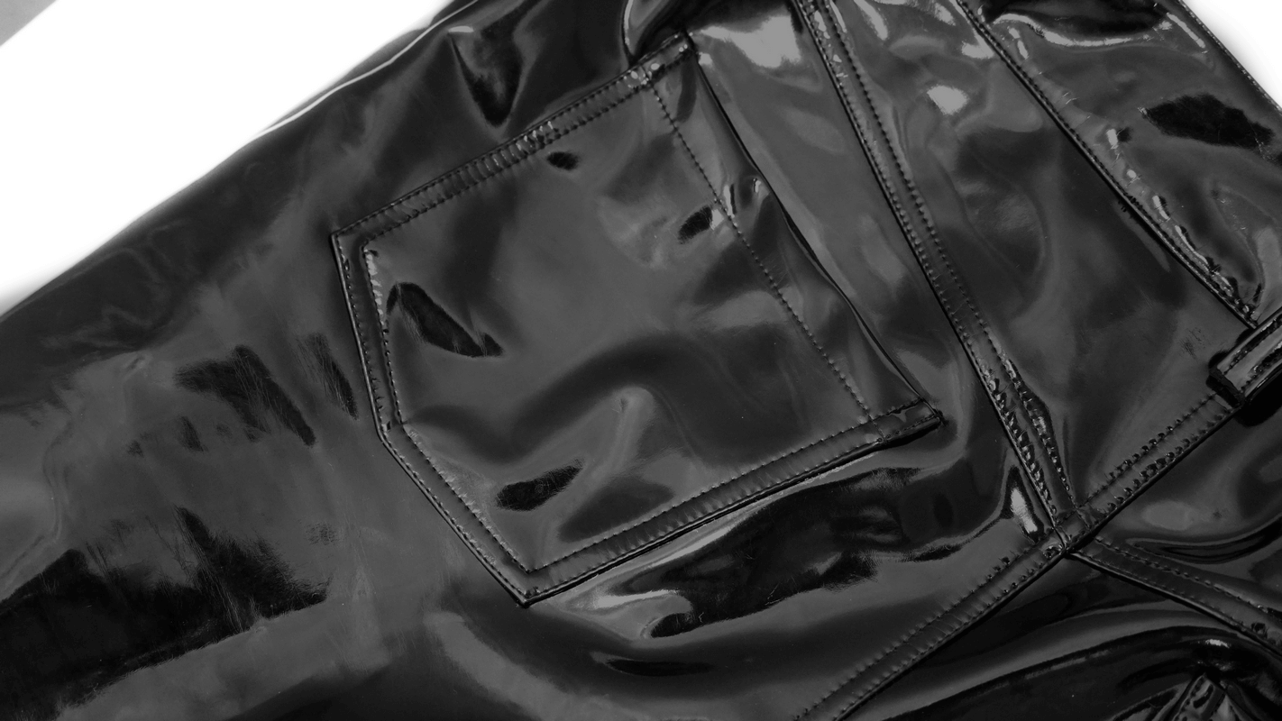 Close-up of black patent PU leather pants, showcasing a stylish pocket and sleek glossy finish, ideal for cyberpunk fashion.