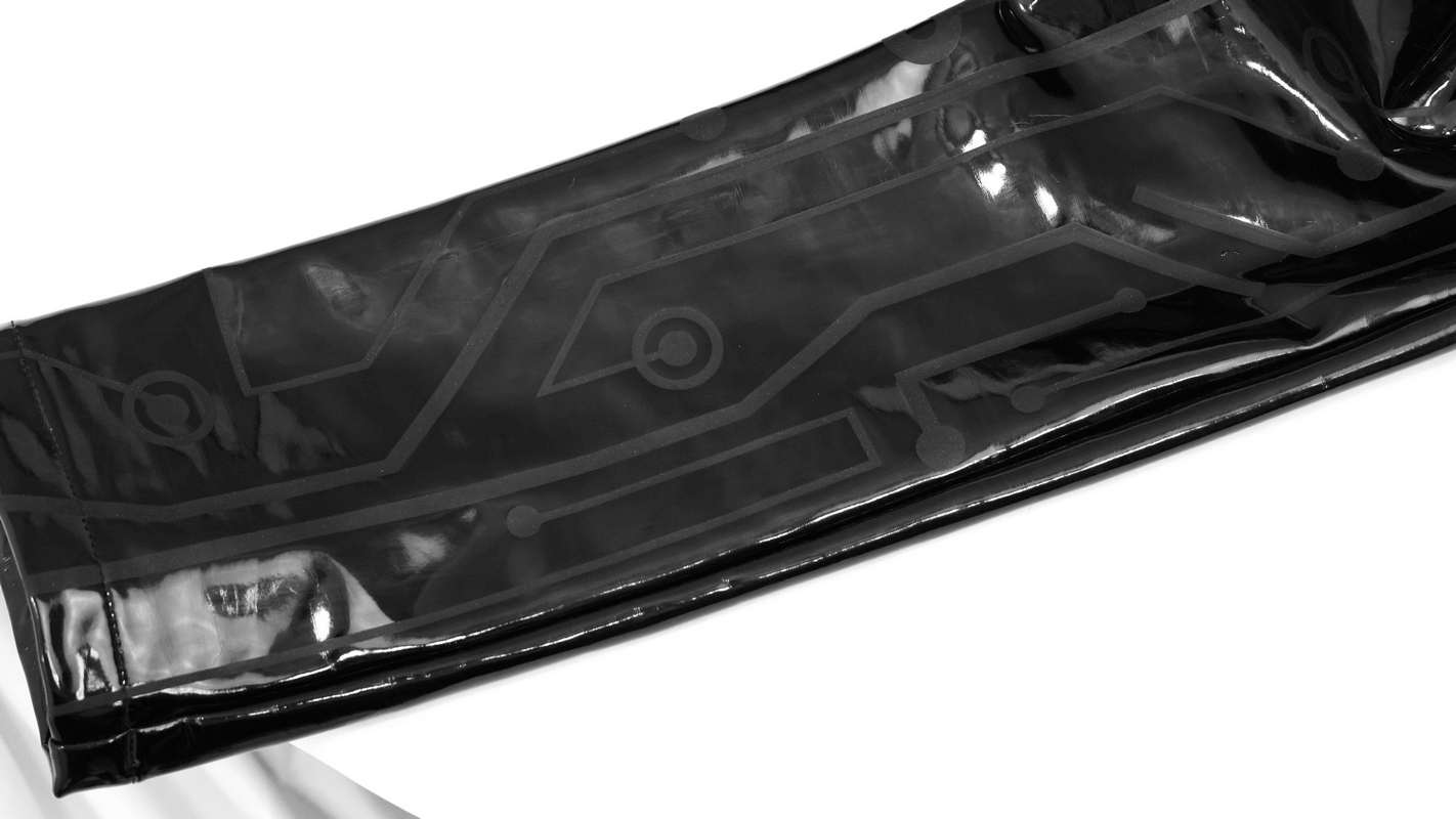 Close-up of men's black patent leather skinny pants with cyberpunk design, featuring a stylish printed pattern.