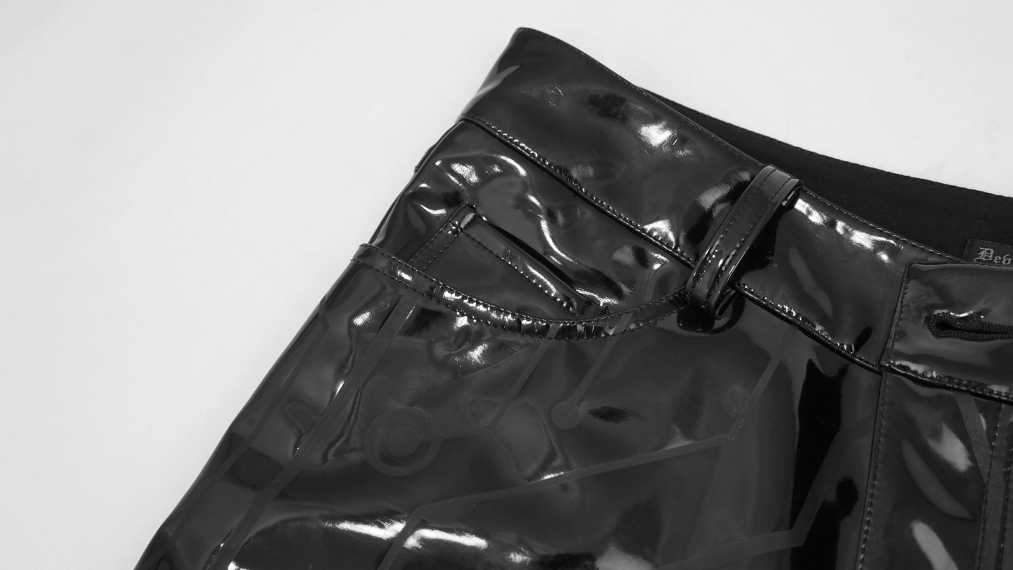 Close-up of men's black patent leather skinny pants featuring a stylish cyberpunk print and tight-fitting design.