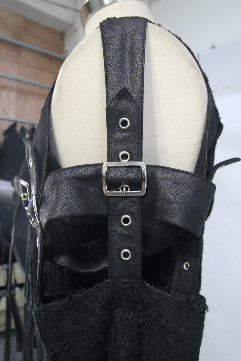 Close-up of black detachable sleeves top with leather straps and buckles, showcasing gothic fashion details.