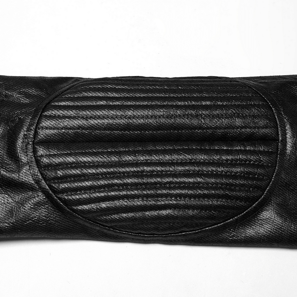 Close-up of a black faux leather jacket sleeve with stitched detailing and padded accents for a gothic look.