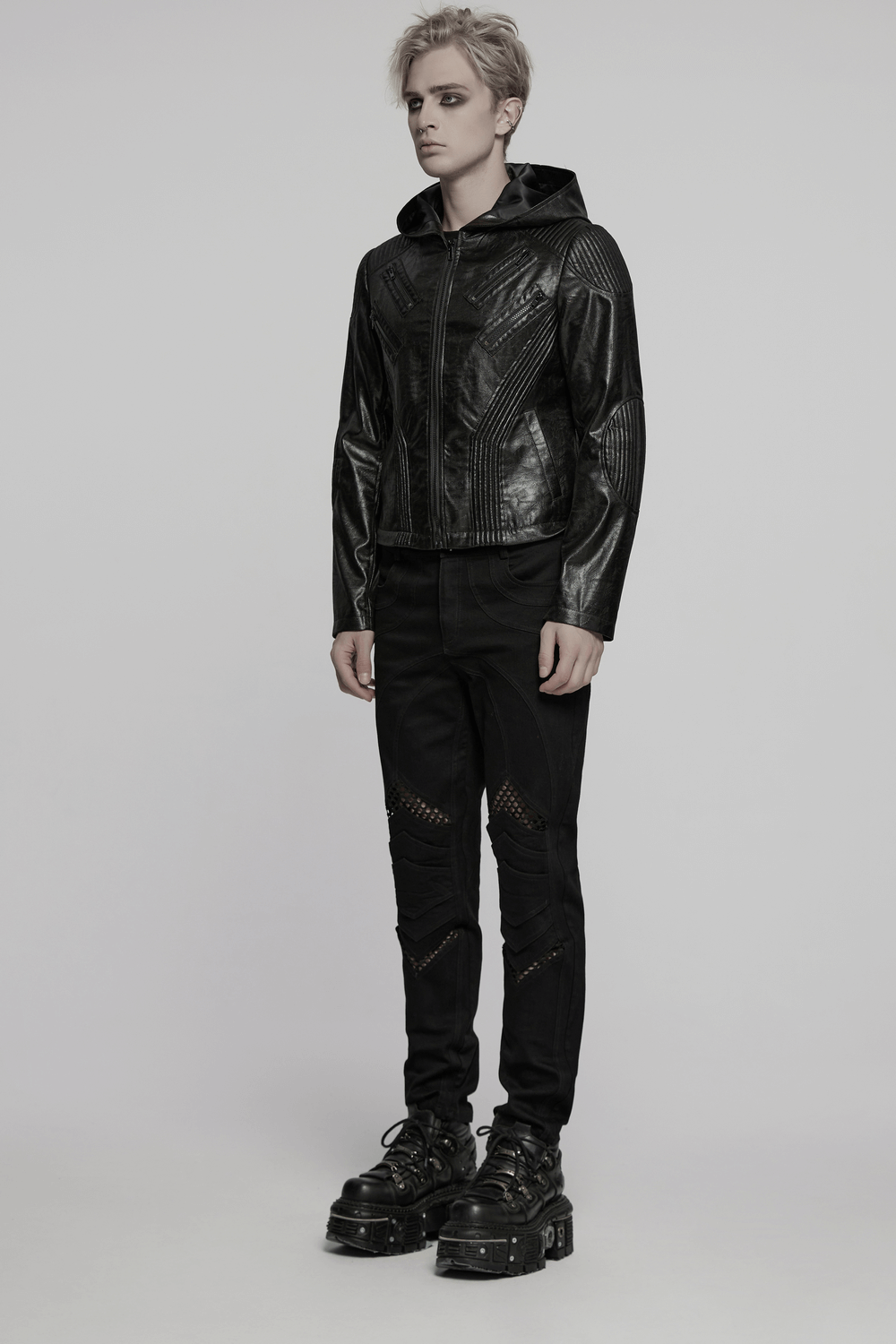 Men's Gothic hooded faux leather long coat jacket for a stylish edgy look, accompanied by trendy black pants and chunky shoes.