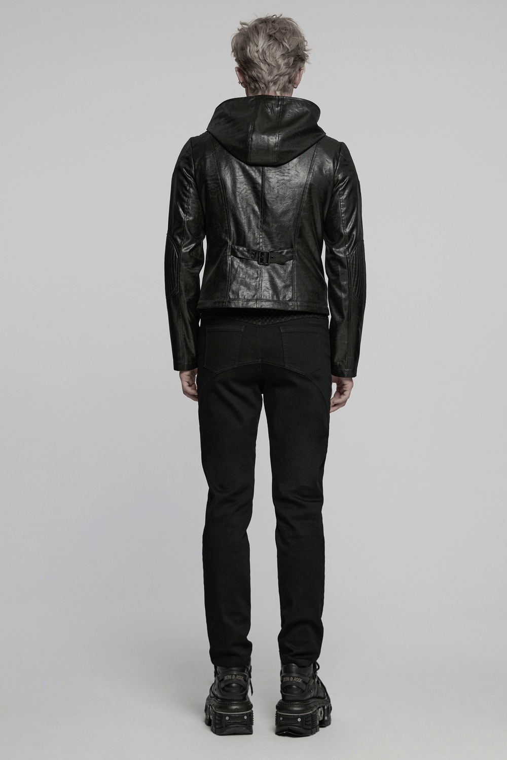 Men's gothic hooded faux leather long coat jacket, stylishly worn from the back with black pants and chunky shoes.