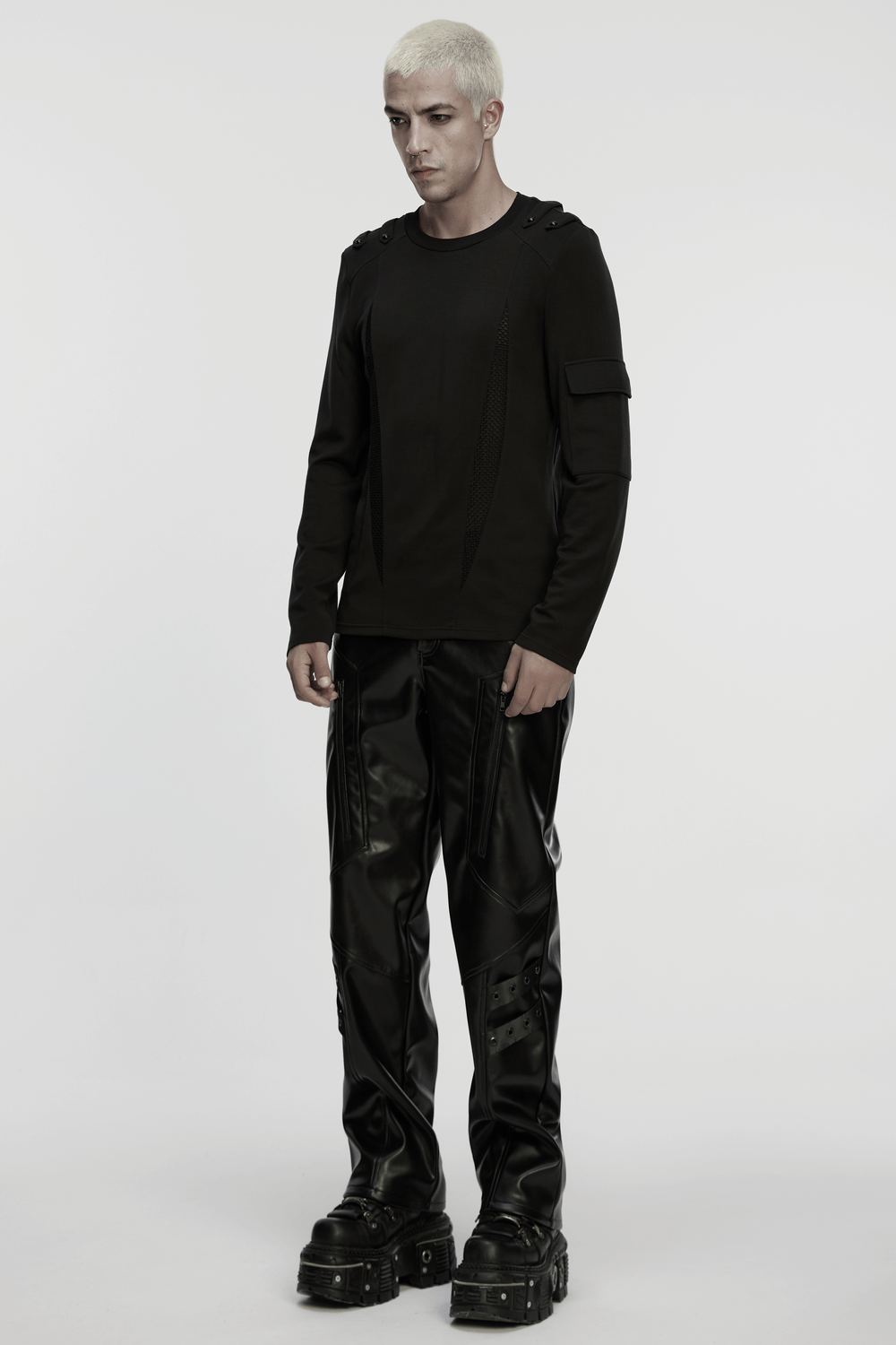 Men's Black Gothic Long-Sleeved Top with Mesh Panels worn with stylish black pants and chunky boots.