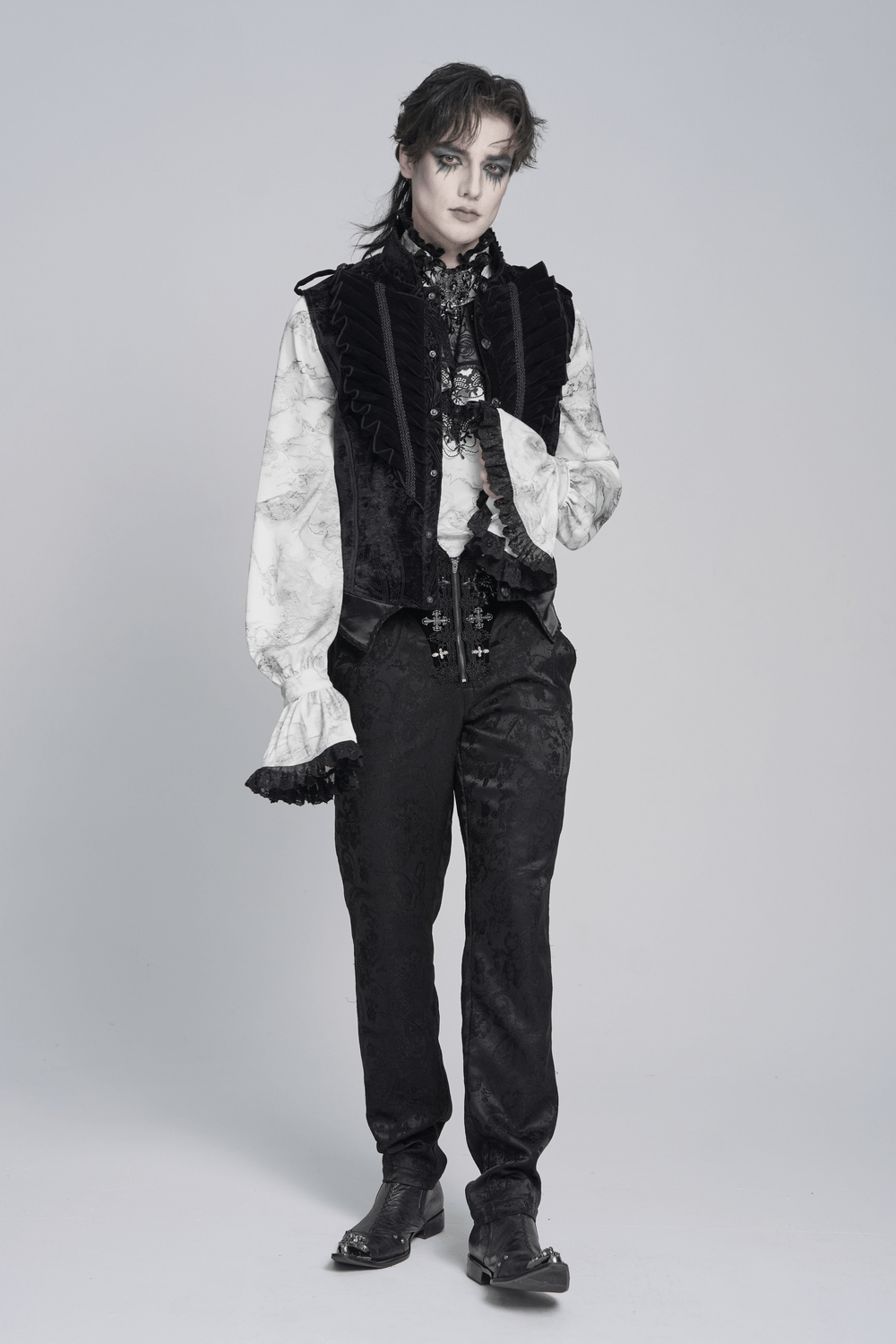 Men's Black Gothic Velvet Waistcoat with Buckles layered over a ruffled white shirt and dark pants for a dramatic look.