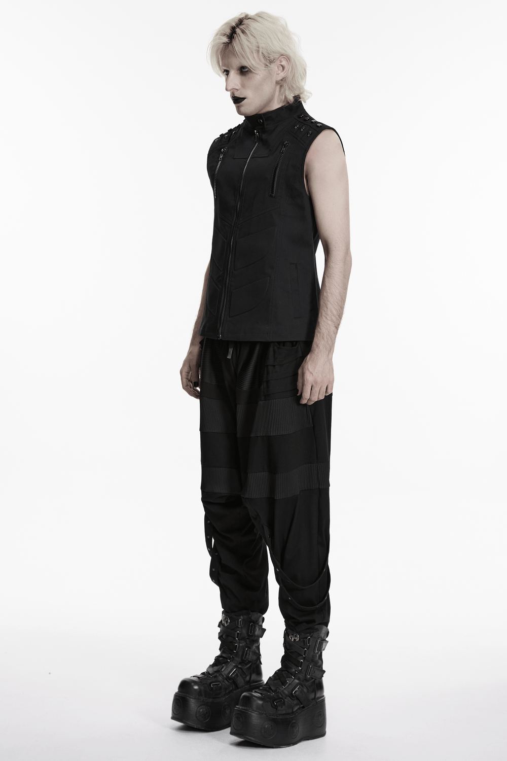 Men's Black Industrial Punk Vest with Rivet Detail worn with black cargo pants and platform boots, styled for cyberpunk aesthetics.