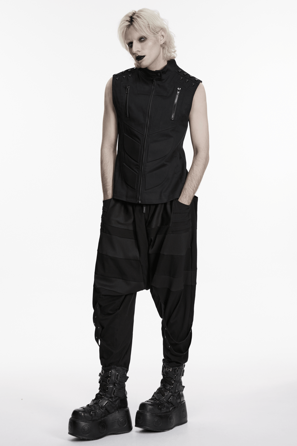 Men's Black Industrial Punk Vest with Rivet Detail worn with black streetwear pants and platform boots, showcasing a cyberpunk style.