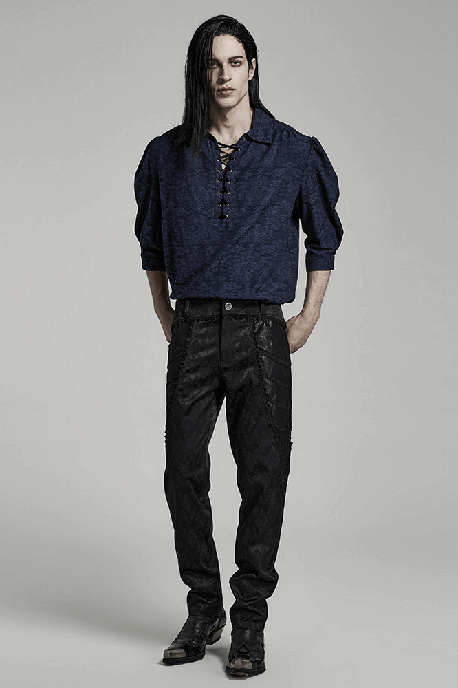 Model showcasing gothic style with black jacquard lace-trim designer pants and a stylish navy top.
