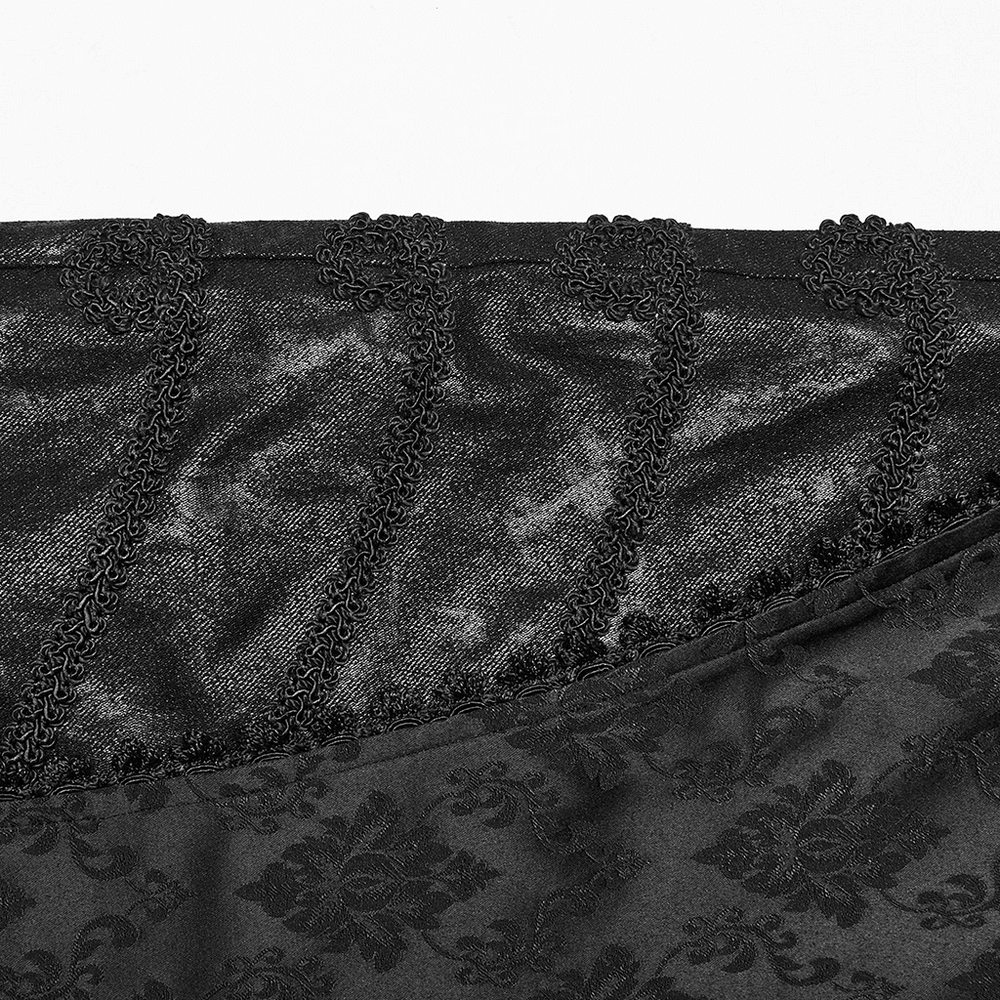 Close-up of elegant black jacquard fabric with intricate lace trim, showcasing gothic style and sophisticated design.