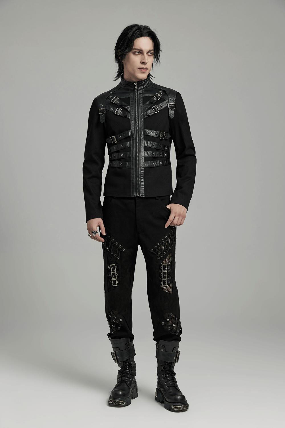 Men's black punk jacket with buckles and zippers, styled with matching edgy pants for a bold biker look.
