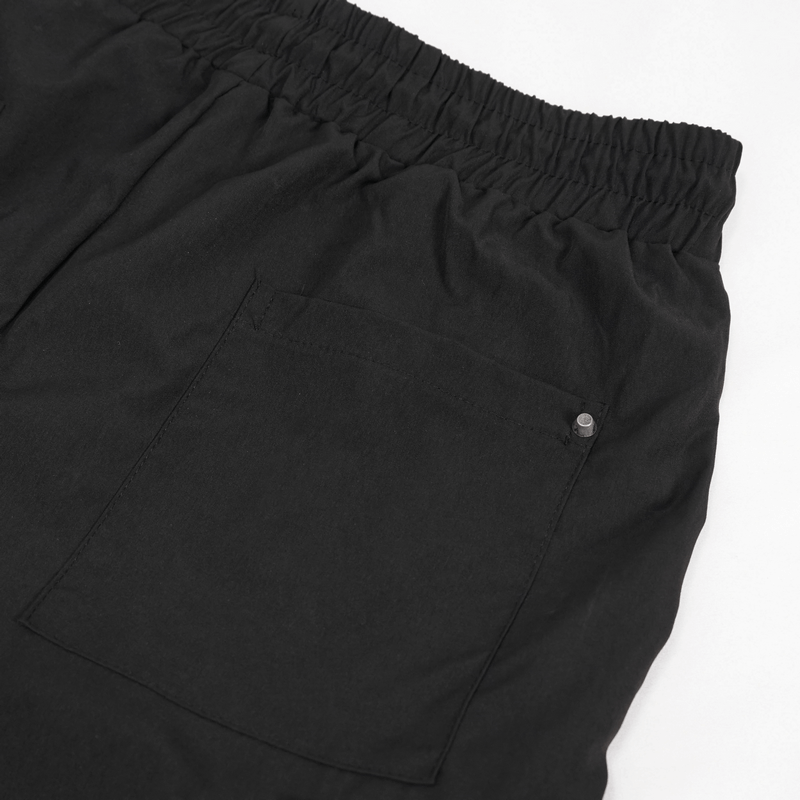 Back view of men's black punk cargo trousers showcasing elastic waistband and pocket detail.