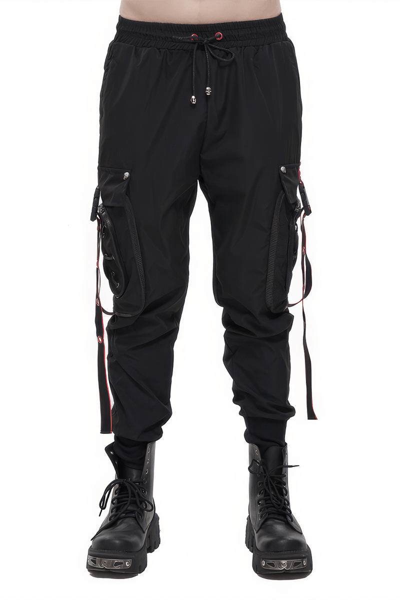 Men's black punk cargo trousers with red accents, featuring a loose fit and stylish side straps, paired with black combat boots.