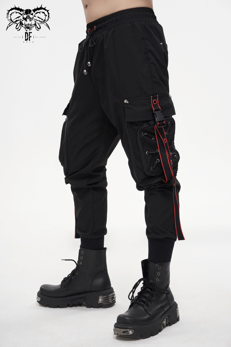Men's black punk cargo trousers with red accents and side straps, styled for comfort and fashion.