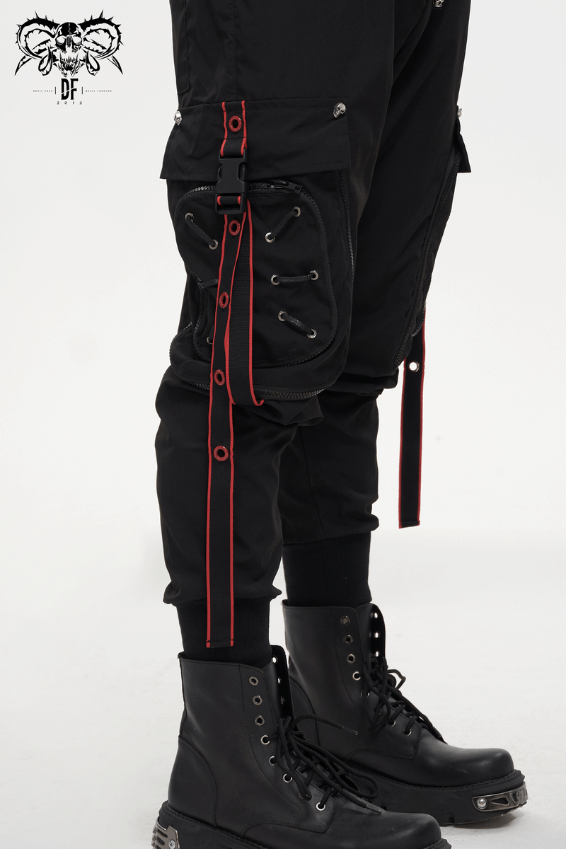 Men's black punk long cargo trousers featuring red accents and stylish side straps, paired with trendy black boots.