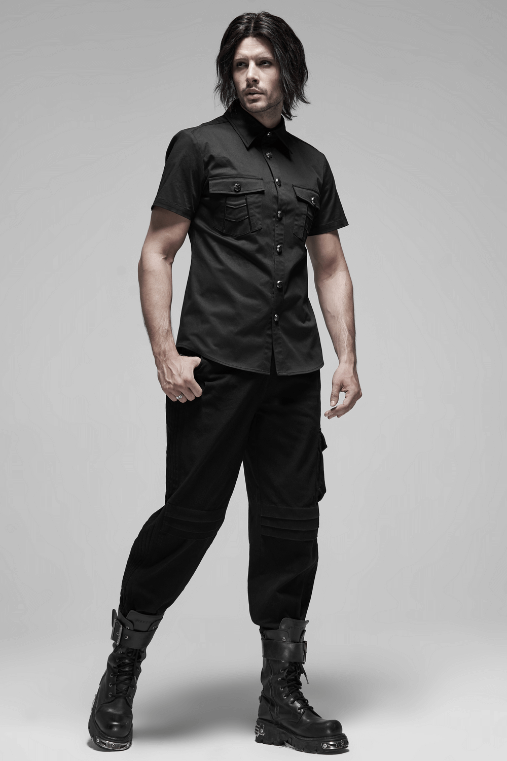 Men's black short-sleeved punk shirt with metal buttons, featuring pockets and a stylish patchwork design. Edgy and modern look.