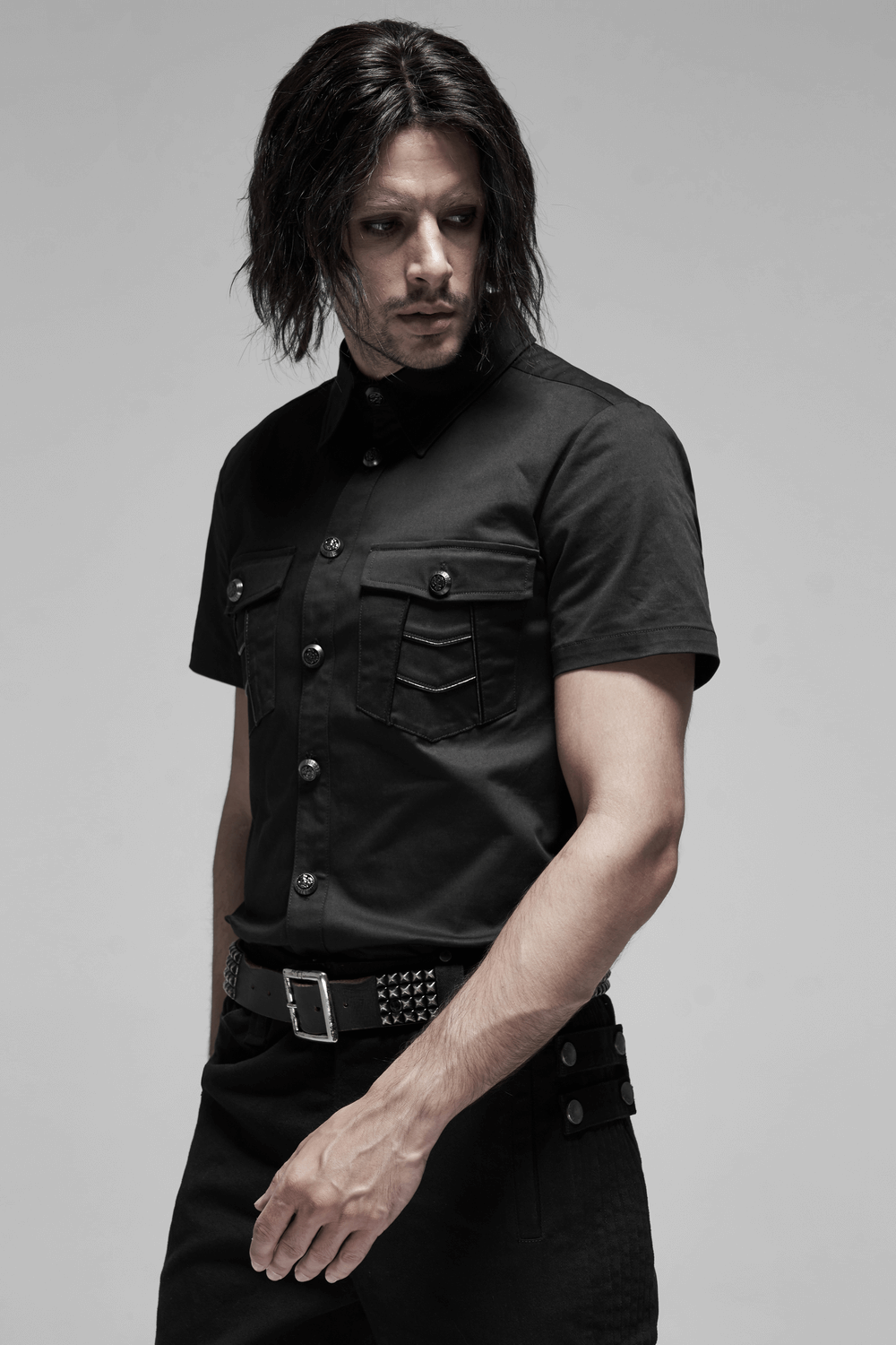 Men's black short sleeved punk shirt with metal buttons, featuring pockets and a unique patchwork design. Stylish and edgy look.