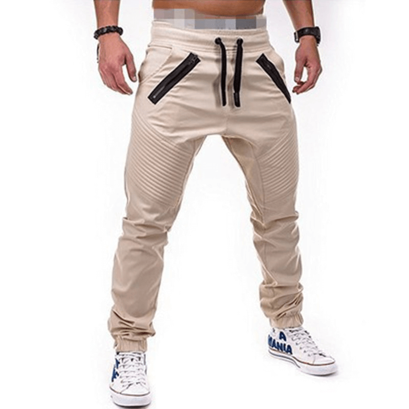 Men's beige joggers with black zippered pockets and stylish design, perfect for casual wear and lounging.