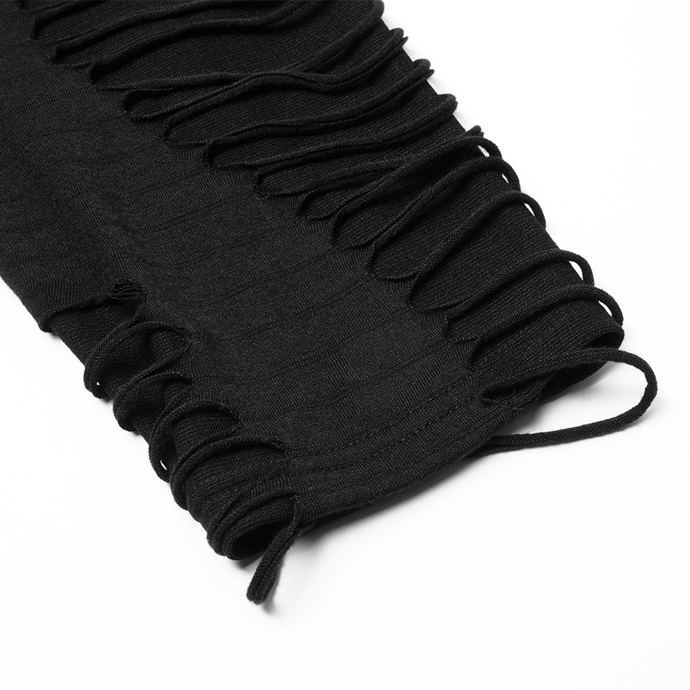 Close-up of distressed black fabric with layered knitting tassels for a gothic sweatshirt.