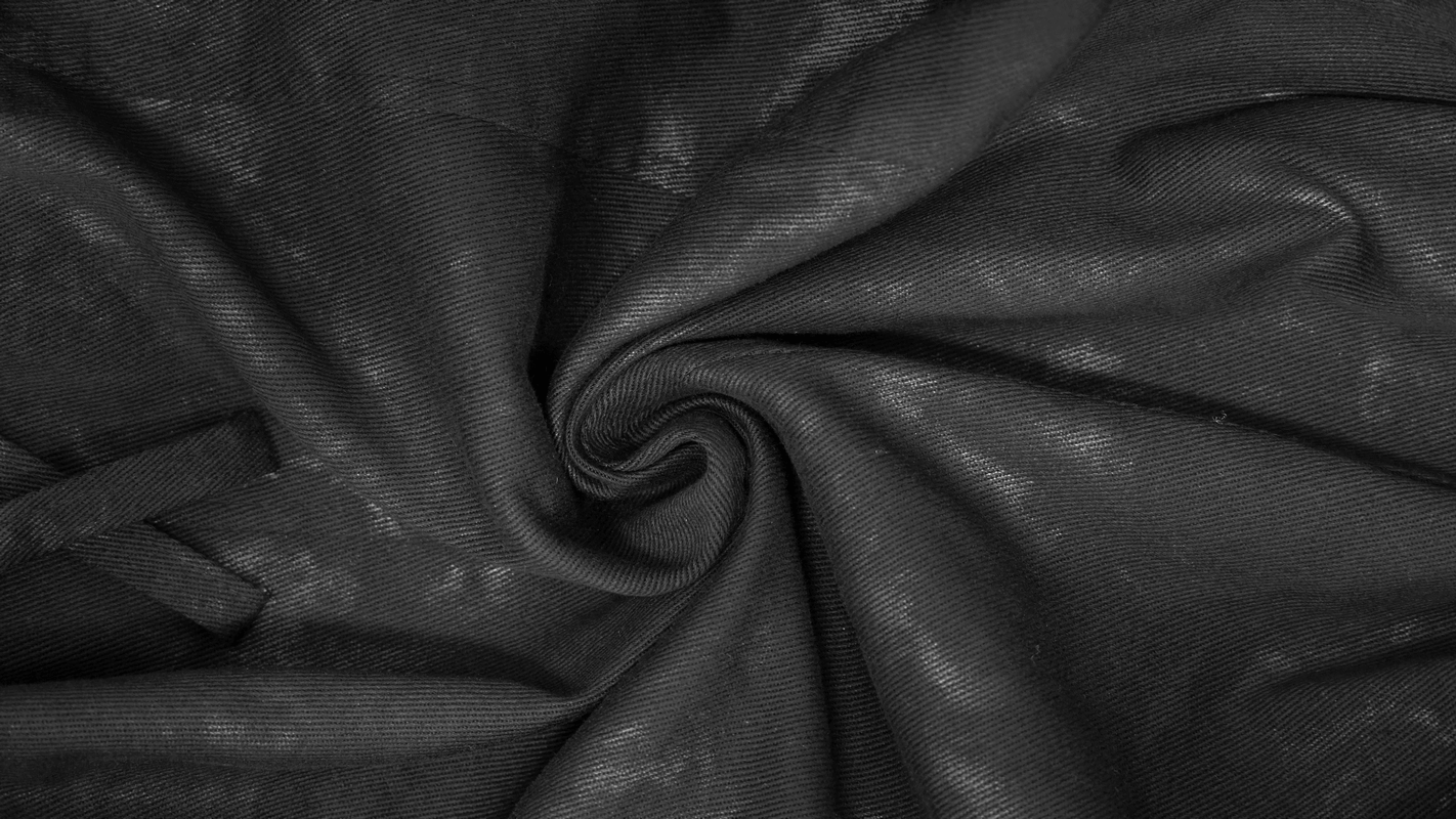 Close-up of black fabric showcasing a stylish texture, ideal for punk-inspired fashion designs.