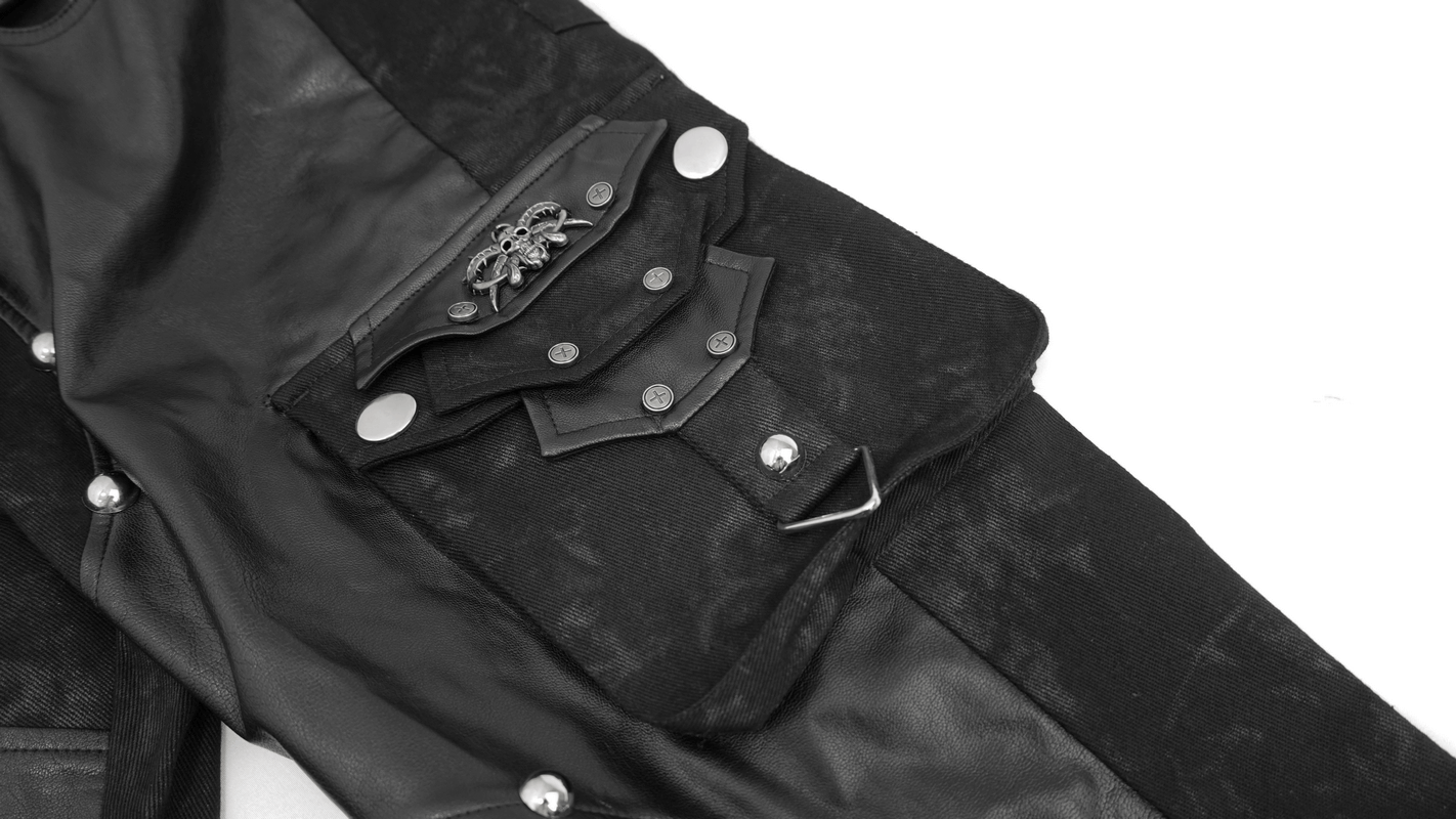 Close-up of men's punk style black faux leather trousers with pockets and silver metal rivets.