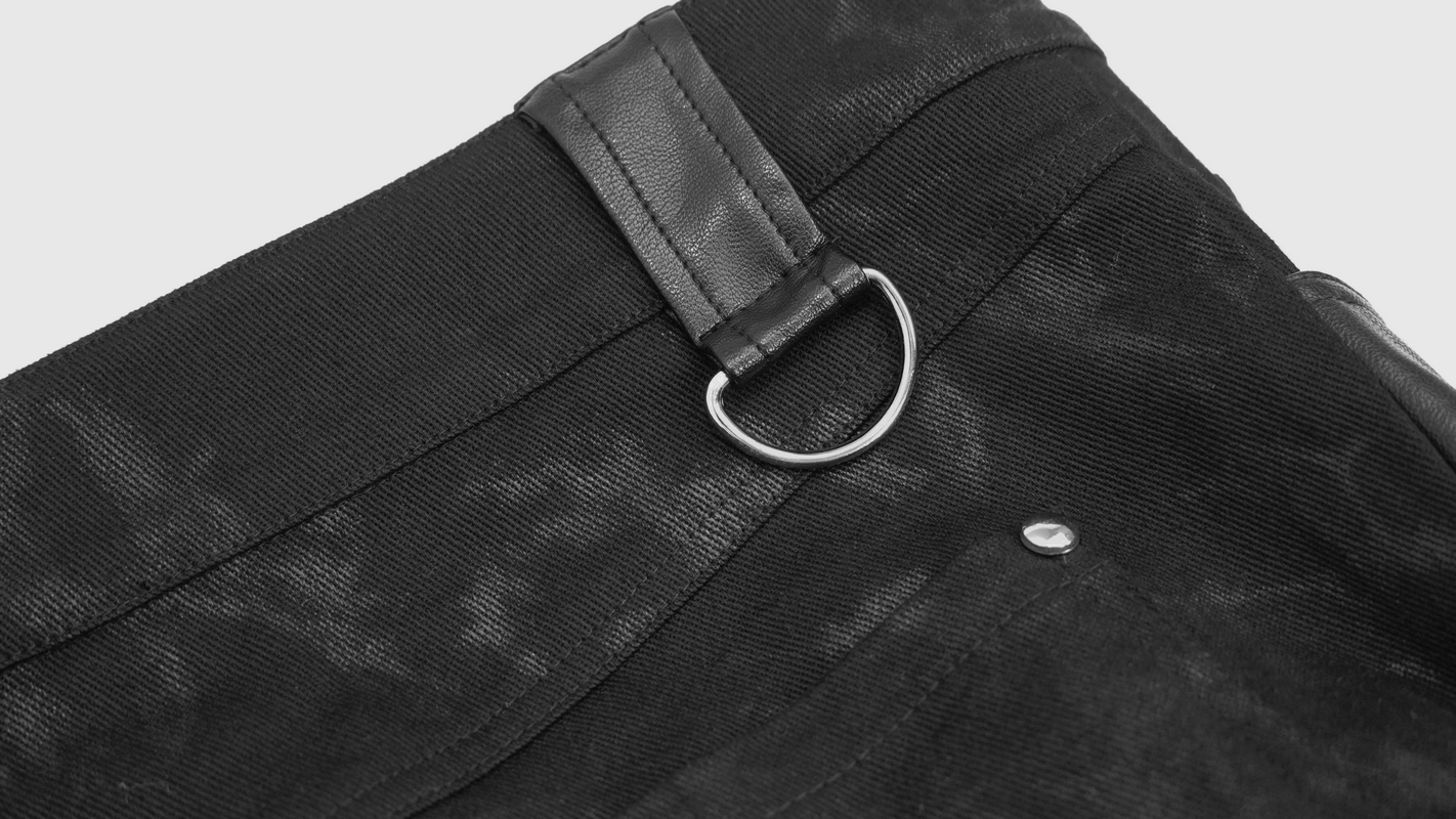 Close-up of men's punk style black trousers featuring a stylish metal ring and fabric detail.