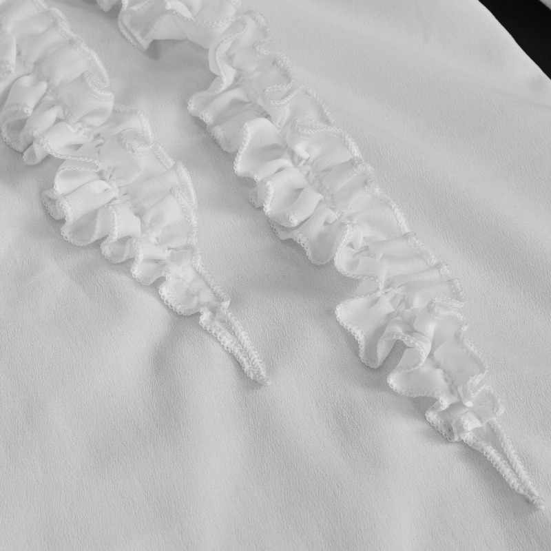 Close-up of ruffled cuffs on a men's vintage white shirt, showcasing elegant fabric and design details.