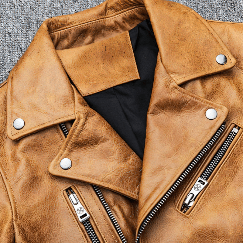 Close-up of a men's genuine leather motorcycle jacket in yellow-brown with silver zippers and a thick turn collar.