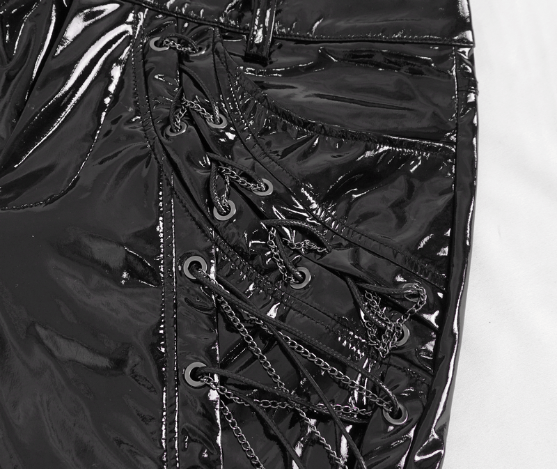 Close-up of Men's glossy leather trousers featuring bold lace-up details and chains in a striking black finish.