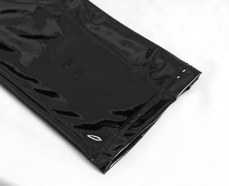 Close-up view of glossy black leather trousers, showcasing sleek finish and stylish lace-up details.