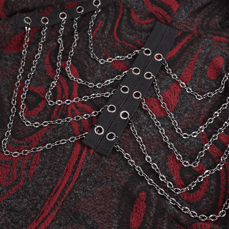 Close-up of gothic coat detailing with chains and eyelets in black and red fabric.