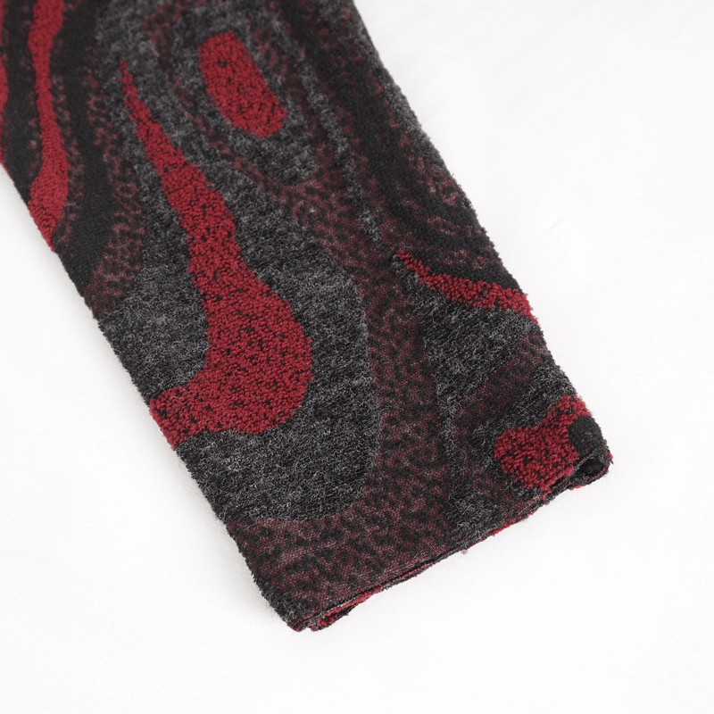 Close-up of the sleeve of a men's goth coat with a striking red and black abstract pattern.