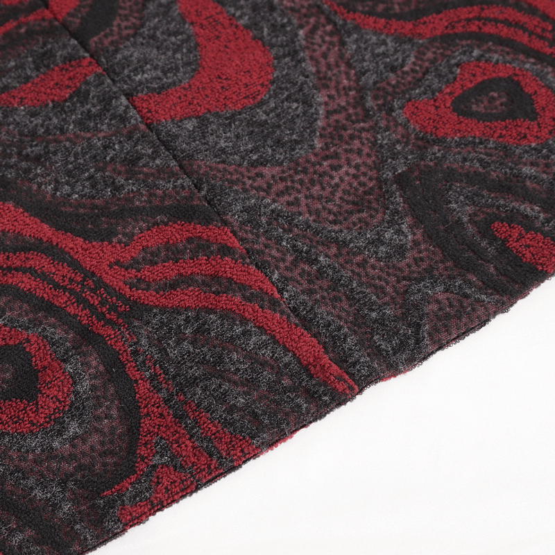 Close-up of men's goth coat fabric featuring intricate red and black patterns.