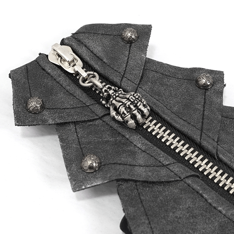 Close-up of gothic black gloves showing skull zipper and rivets on PU leather fabric.