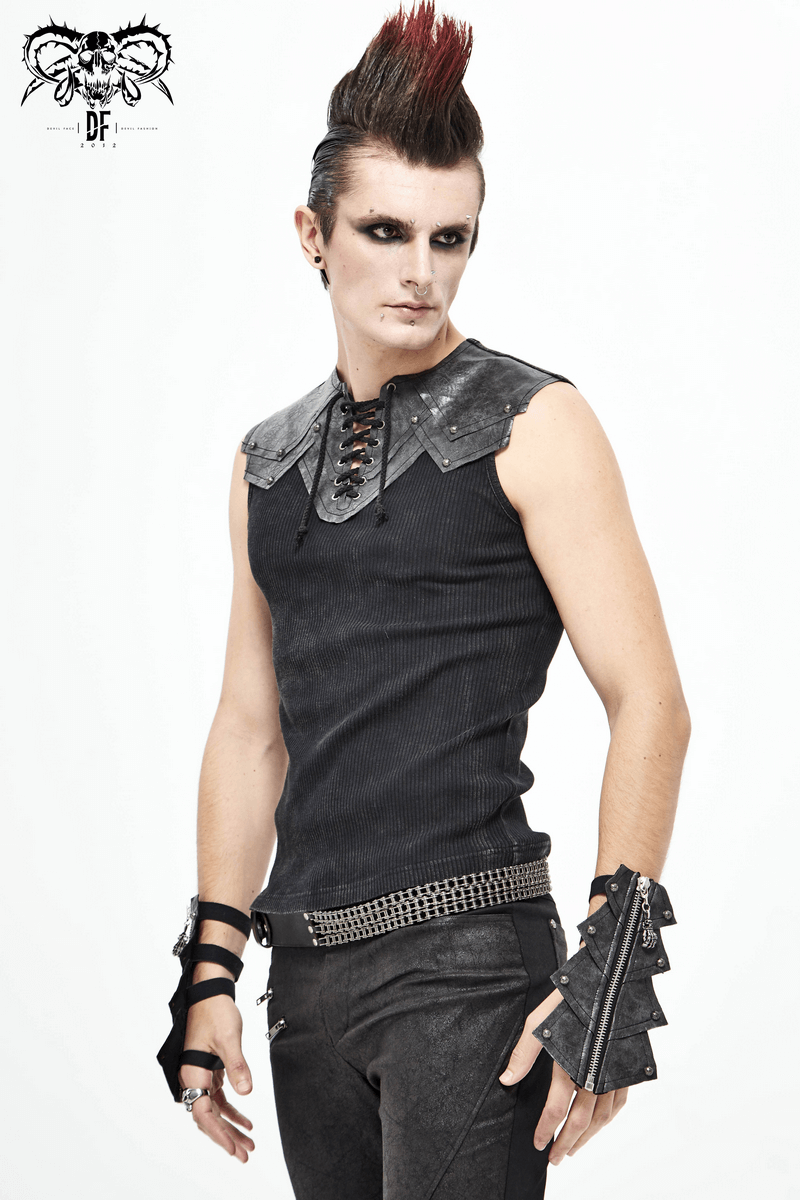 Stylish gothic man in black sleeveless shirt and edgy gloves, showcasing a punk rock fashion statement.