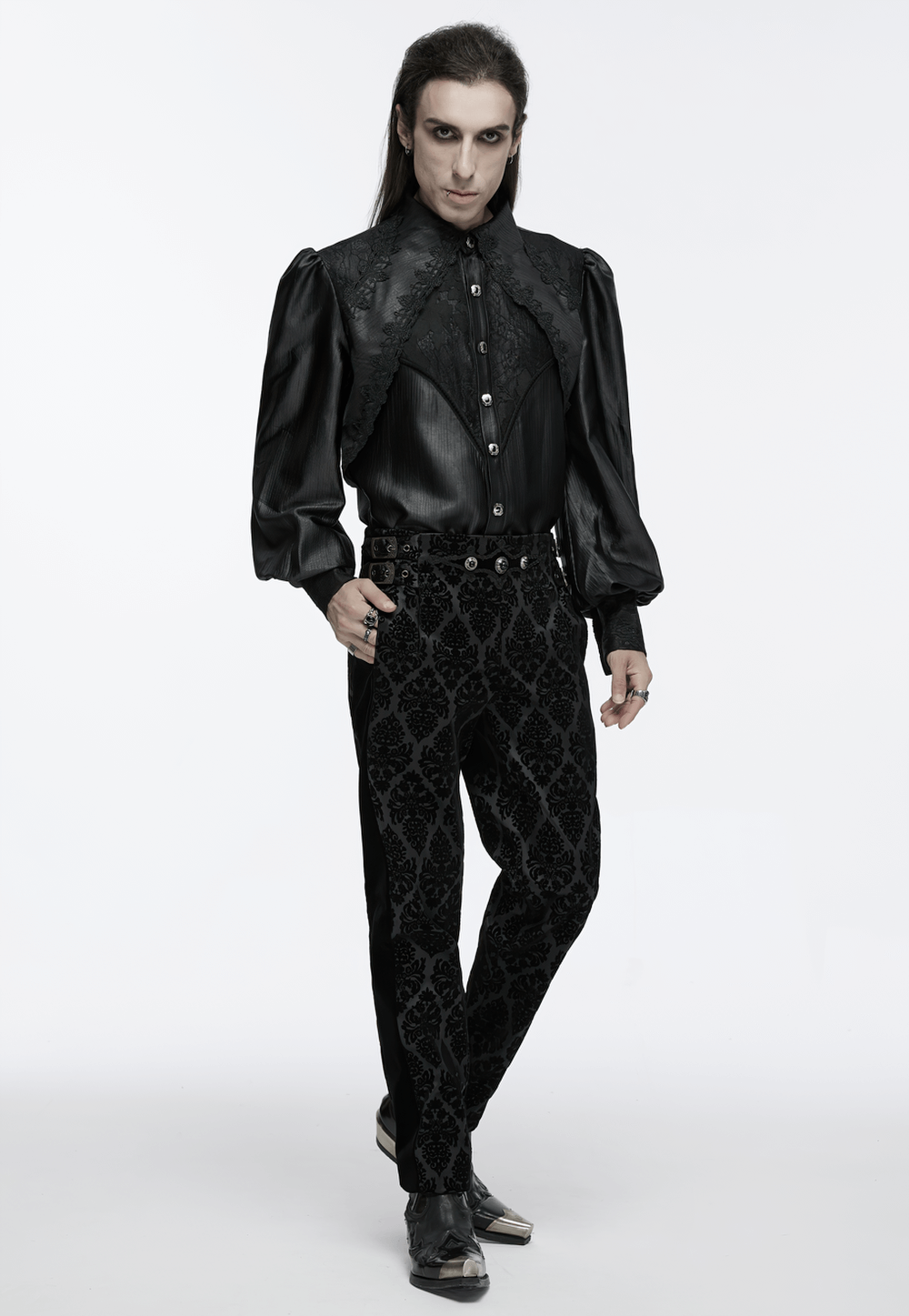 Stylish man in a men's gothic black lace shirt with bubble sleeves and patterned pants, showcasing an elegant dark aesthetic.