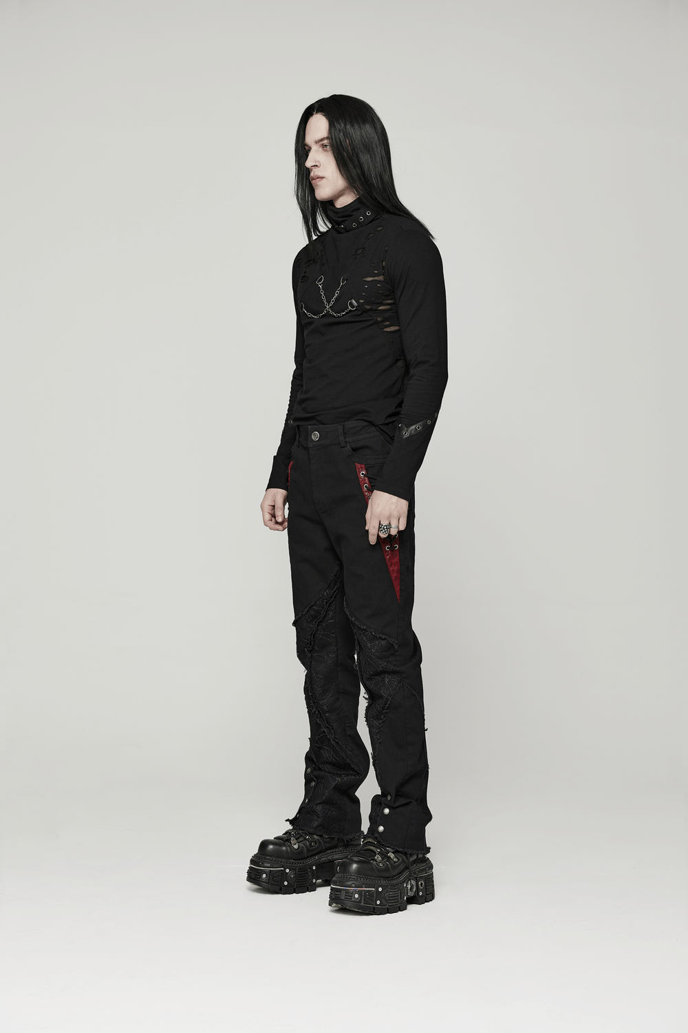 Men's Gothic long sleeve top with chains and broken holes, styled with edgy punk pants and chunky boots.
