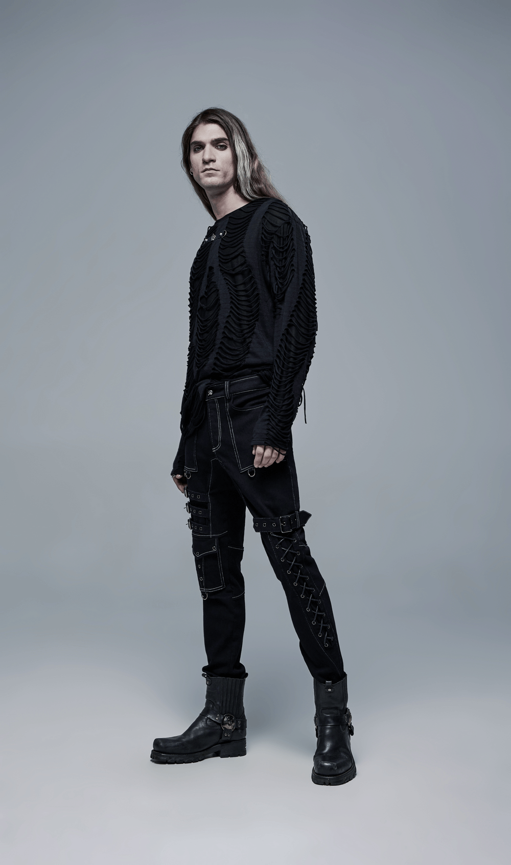 Men's Gothic buckled cargo pants styled with a black long-sleeve top, showcasing punk fashion with strap accents.