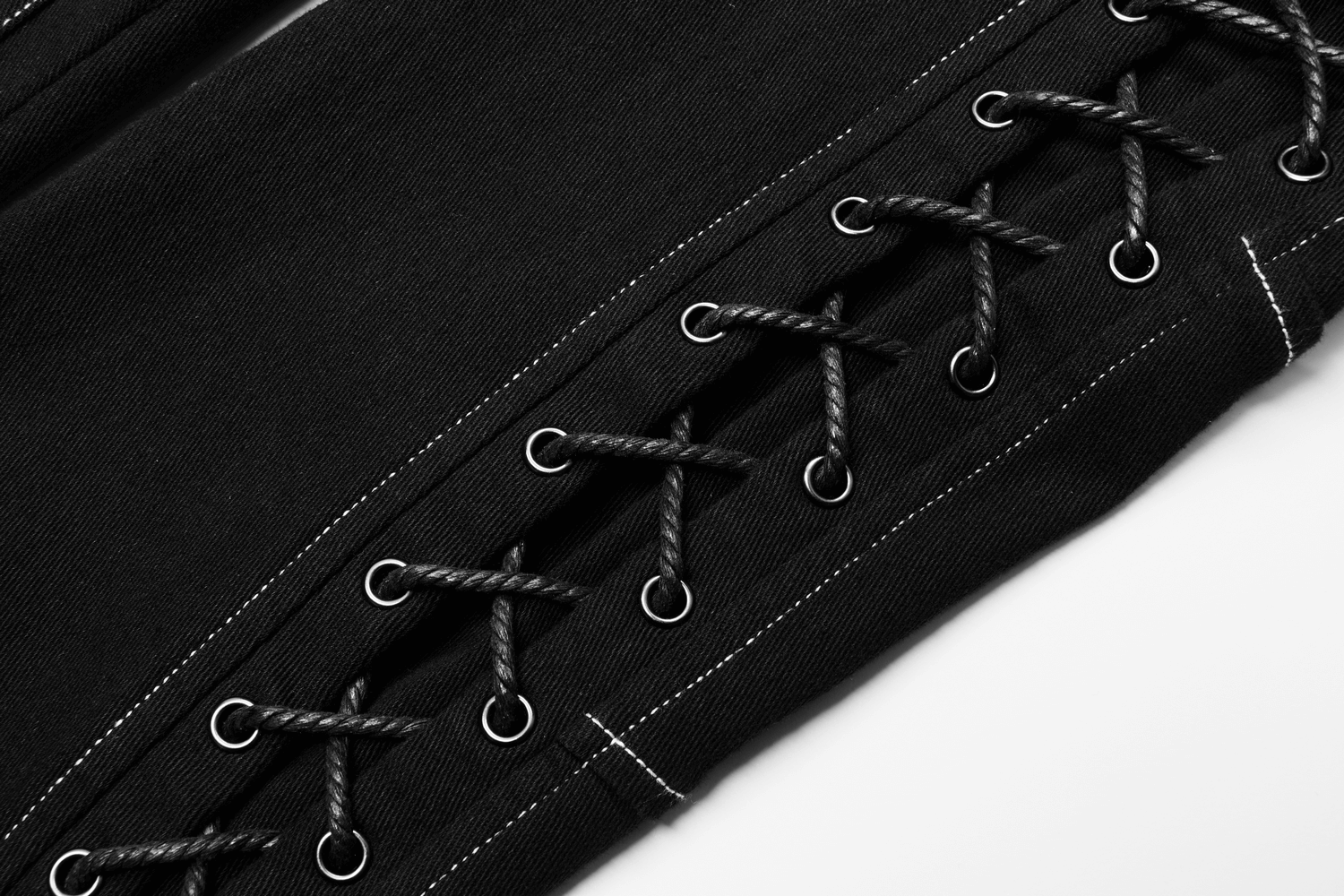 Close-up of men's gothic cargo pants featuring lace-up strap details and contrasting white stitching accents.