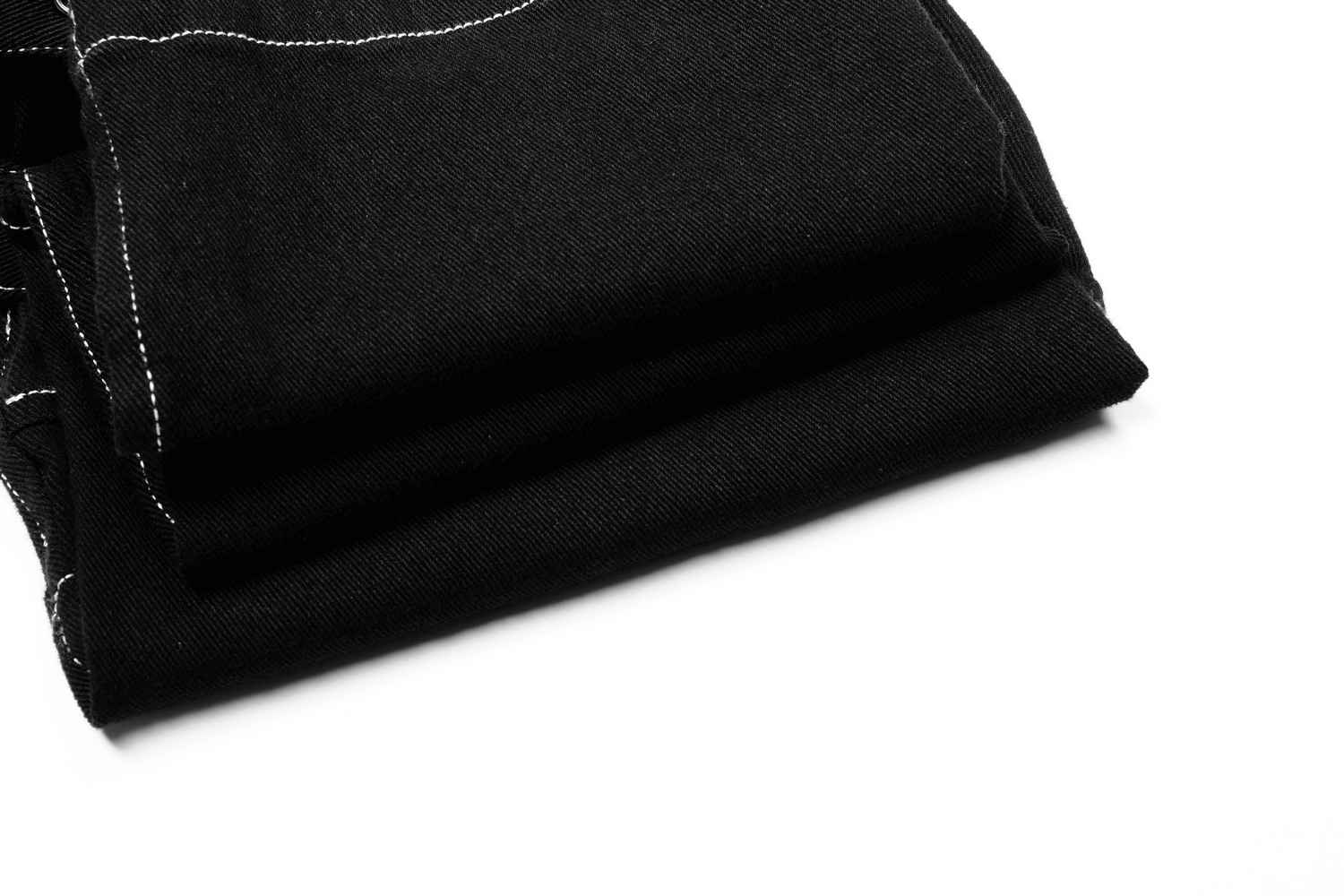 Men's Gothic buckled cargo pants folded, showcasing sleek black fabric with white thread accents for a punk-inspired look.