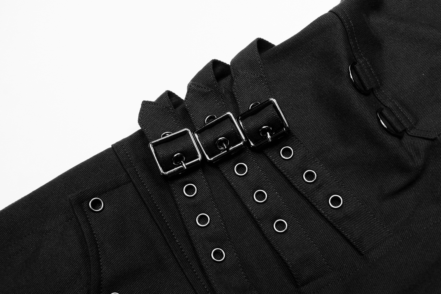 Close-up of black Gothic cargo pants featuring buckles and lace-up details for a punk-inspired look.
