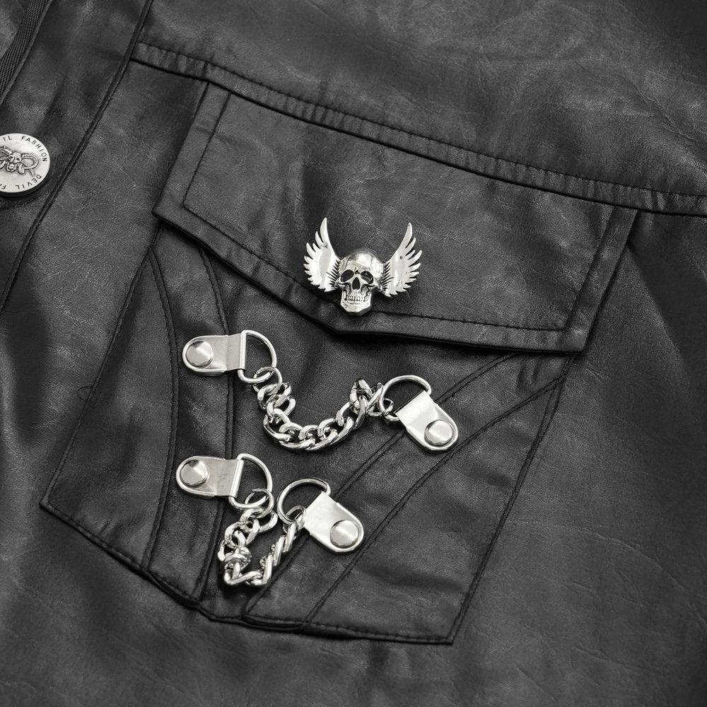 Close-up of men's gothic shirt showing silver skull and wing brooch with chain detail on black faux leather fabric.