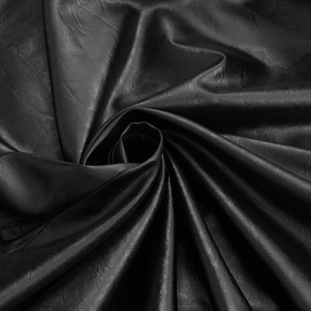 Close-up of luxurious black faux leather fabric, showcasing its soft texture and elegant sheen, perfect for gothic fashion.