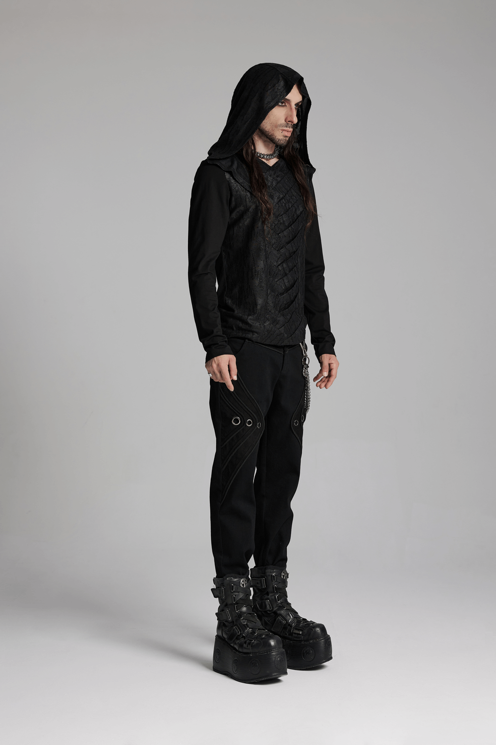 Men's gothic hooded top in black with unique front design, paired with edgy pants and chunky boots for a bold look.