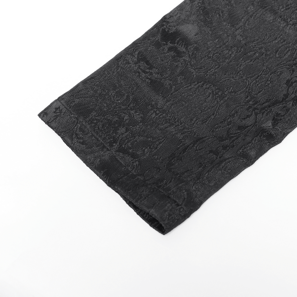 Close-up of men's gothic jacquard pants showcasing intricate black brocade fabric and detailed texture.