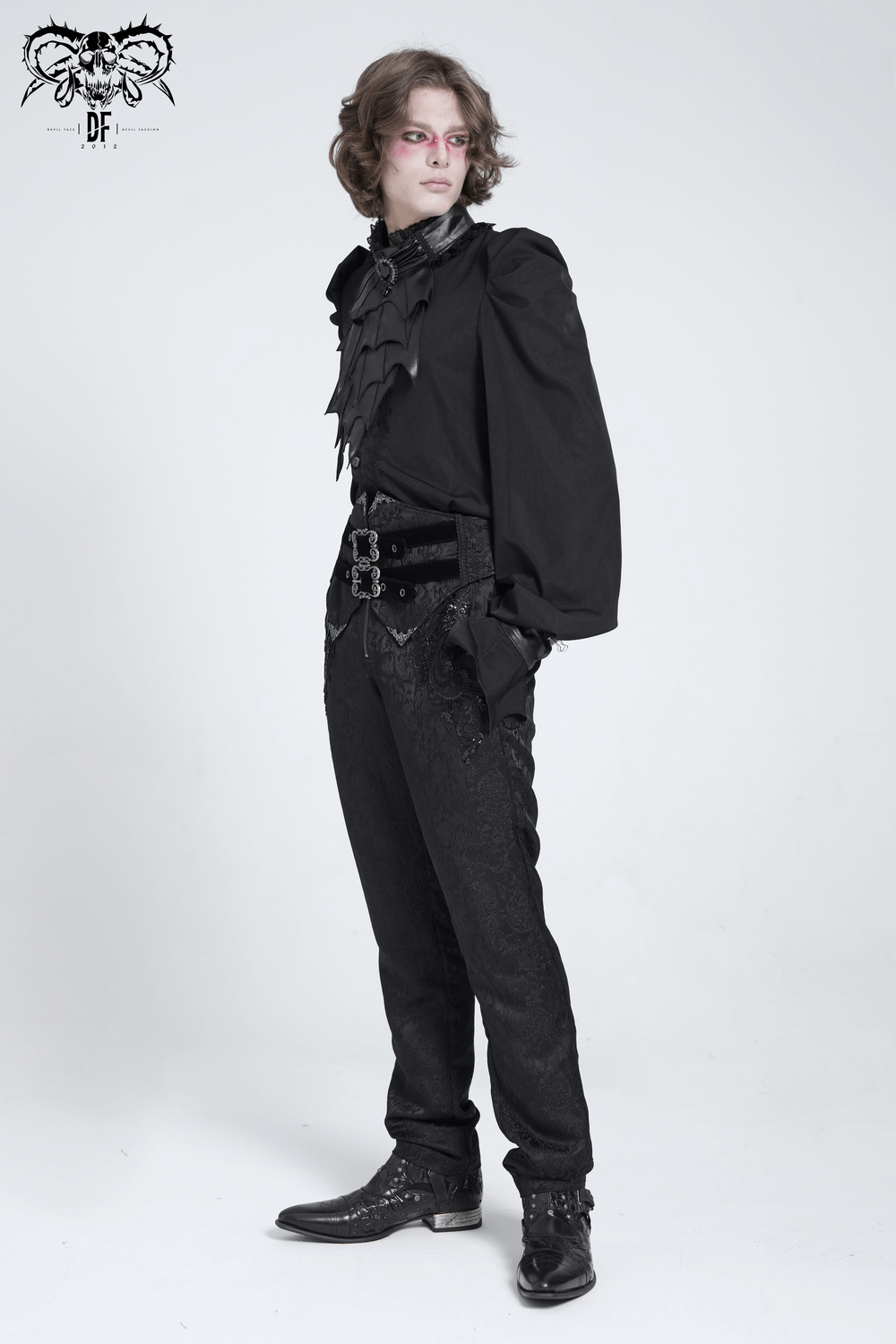 Men's gothic jacquard pants with buckles and ornate brocade pattern, styled with a dramatic black shirt.