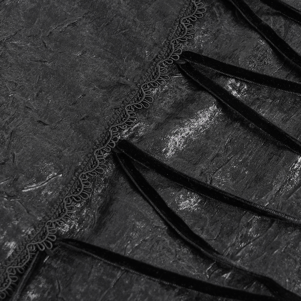 Close-up of textured black fabric with lace trim and lace-up detailing, perfect for gothic fashion.