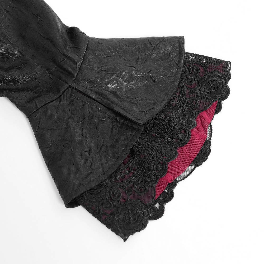 Close-up of black gothic shirt with ruffled lace cuffs and burgundy lining, showcasing elegant Victorian details.